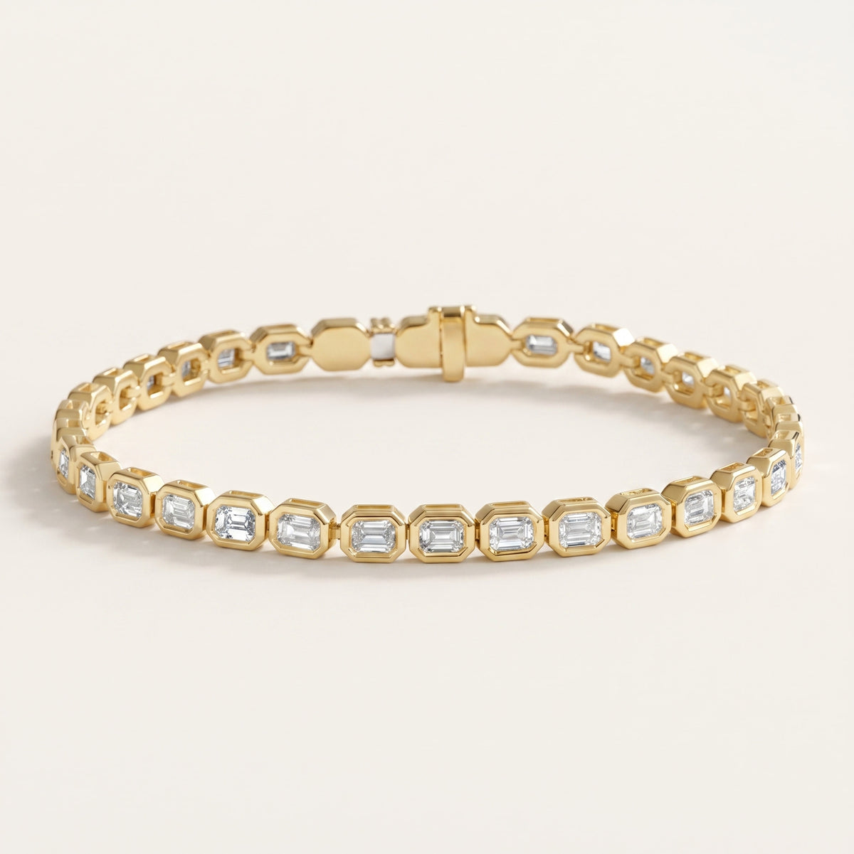 bezel-set emerald cut diamond tennis bracelet in gold