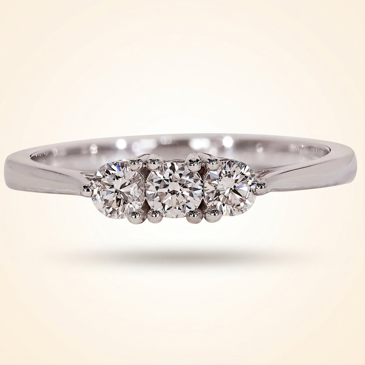 three-stone round diamond shared-prong band