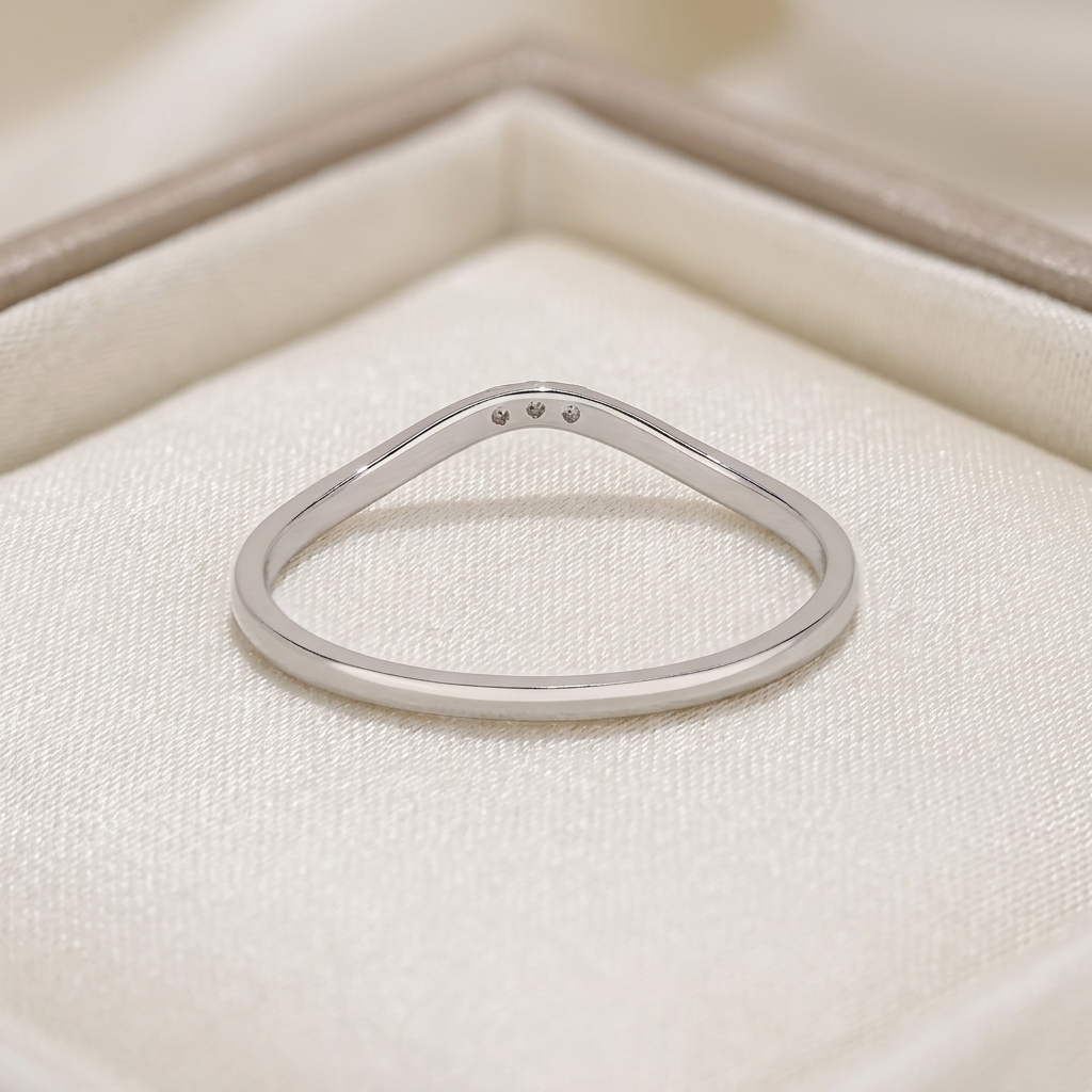 curved three-stone diamond chevron wedding band in gold