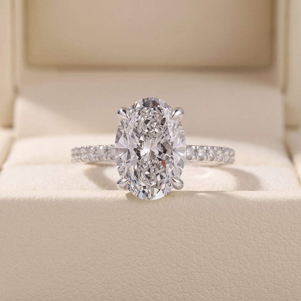 oval cut diamond engagement ring with pave band and hidden halo