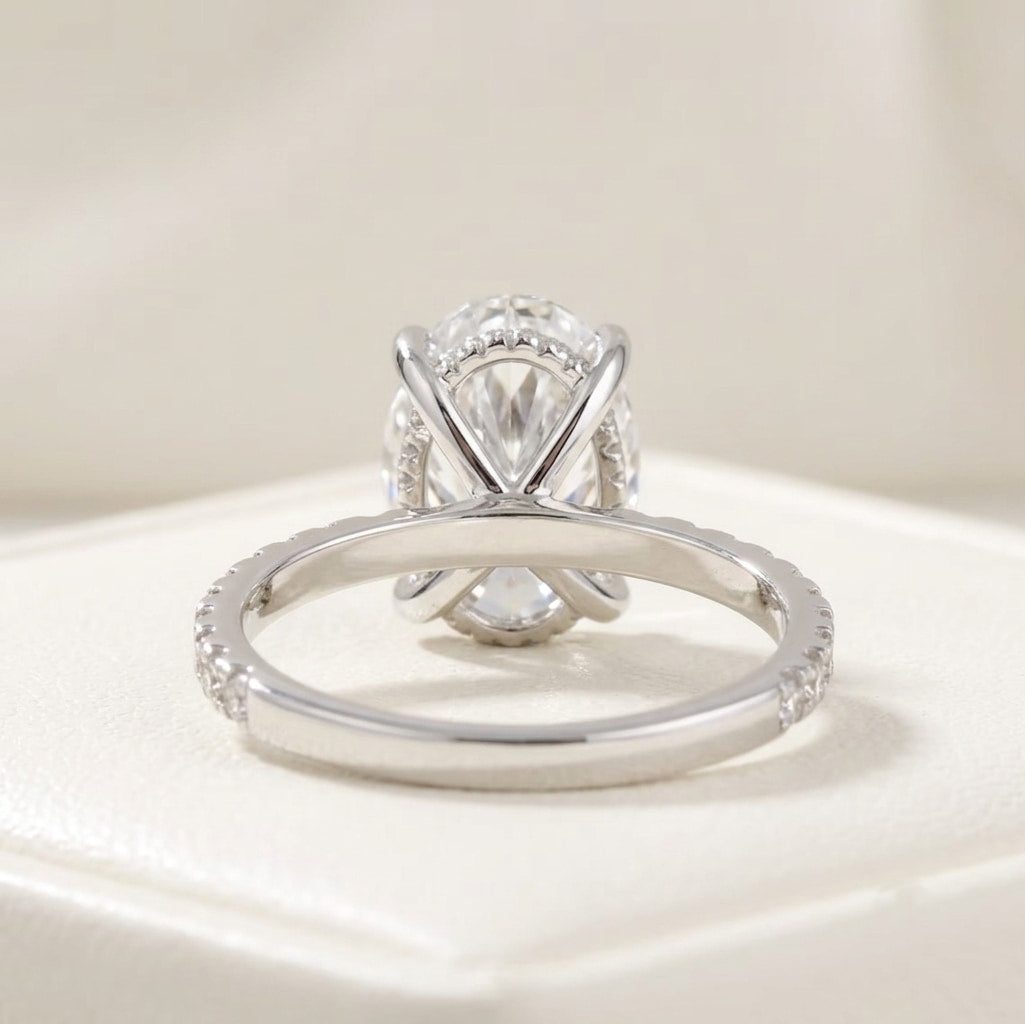 oval cut diamond engagement ring with pave band and hidden halo
