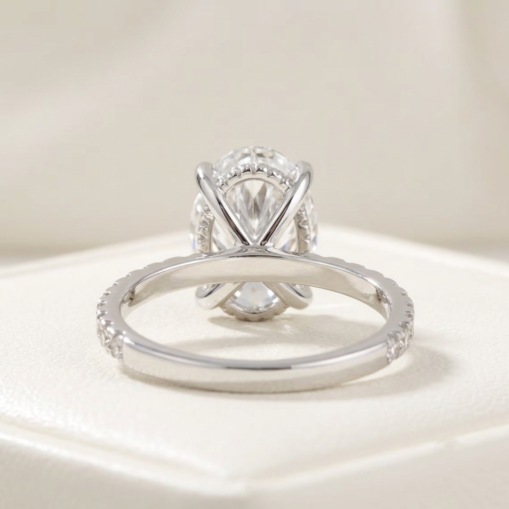 oval cut diamond engagement ring with pave band and hidden halo