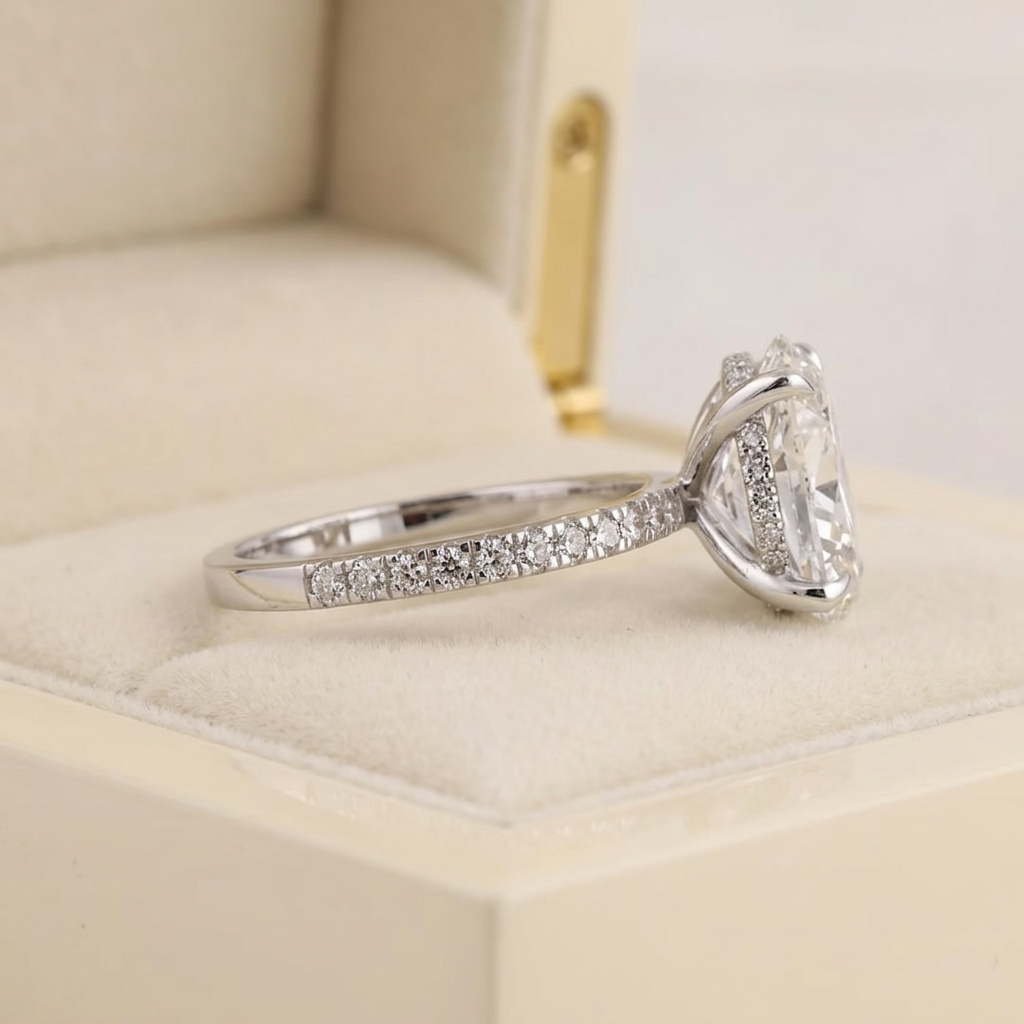 oval cut diamond engagement ring with pave band and hidden halo