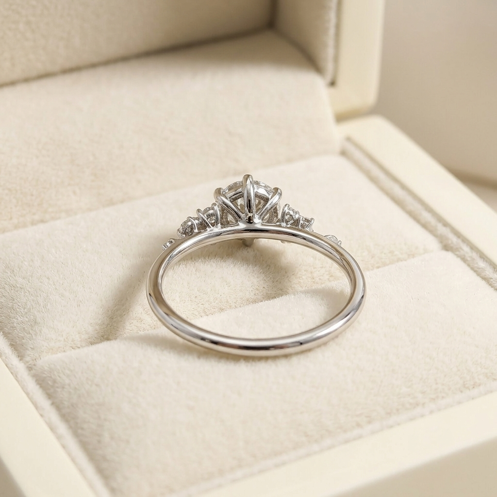 round brilliant diamond cluster engagement ring with asymmetric side accents