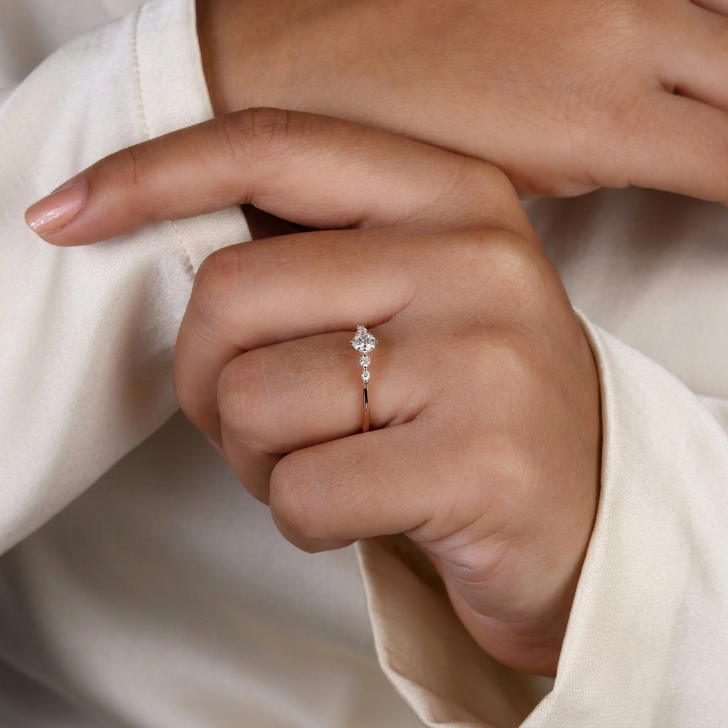 round cut diamond engagement ring with graduated side stones and petal gallery