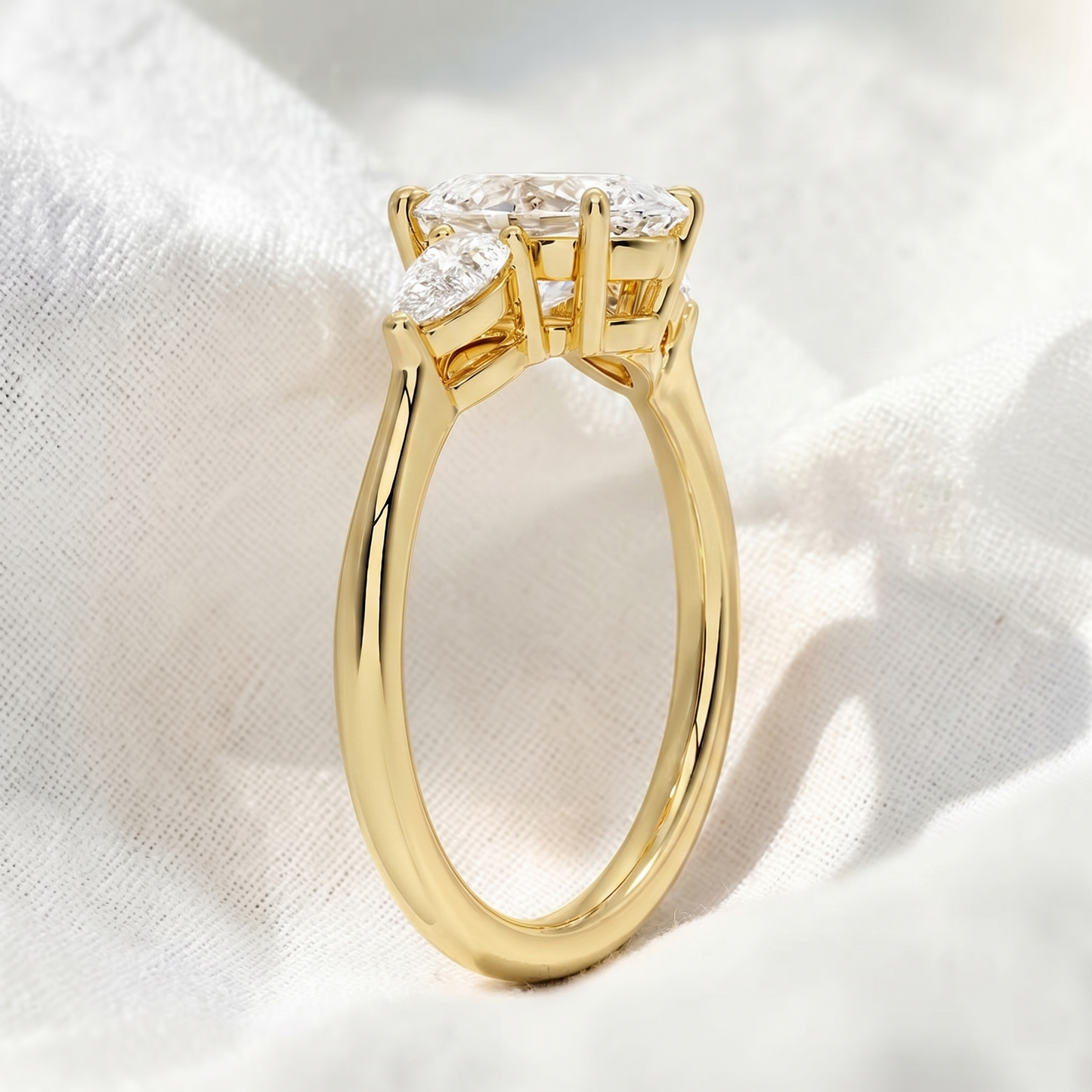 oval lab grown diamond three stone engagement ring with pear side stones