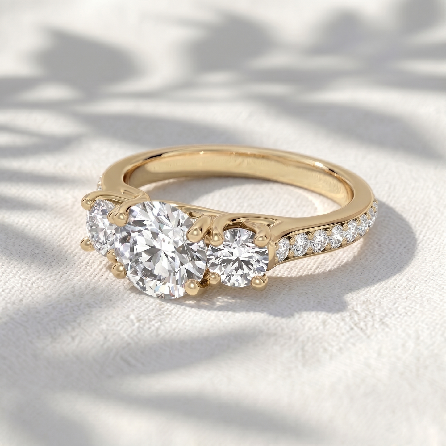 round lab grown diamond three stone engagement ring with pavé band