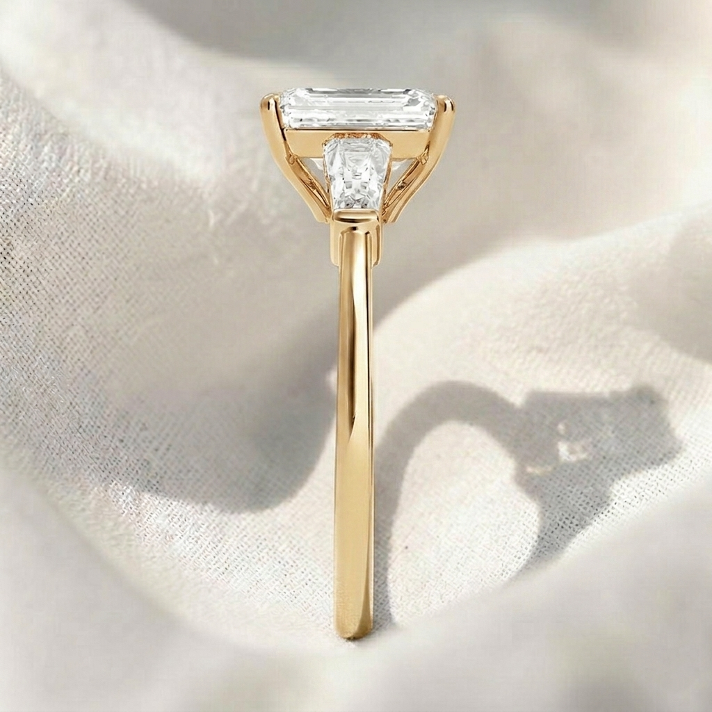 emerald cut lab grown diamond three stone engagement ring with tapered baguette side stones