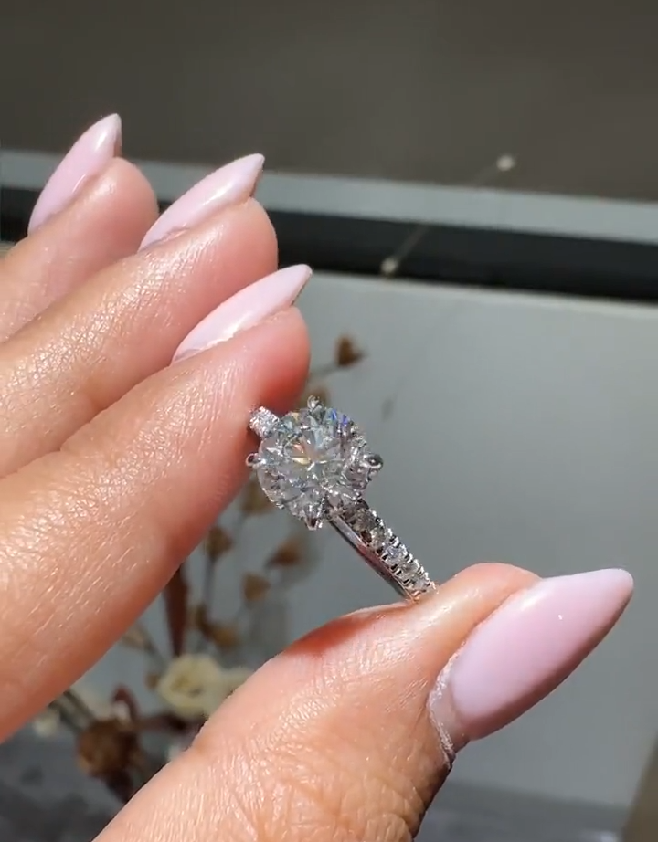 round cut diamond engagement ring with pave band and hidden halo