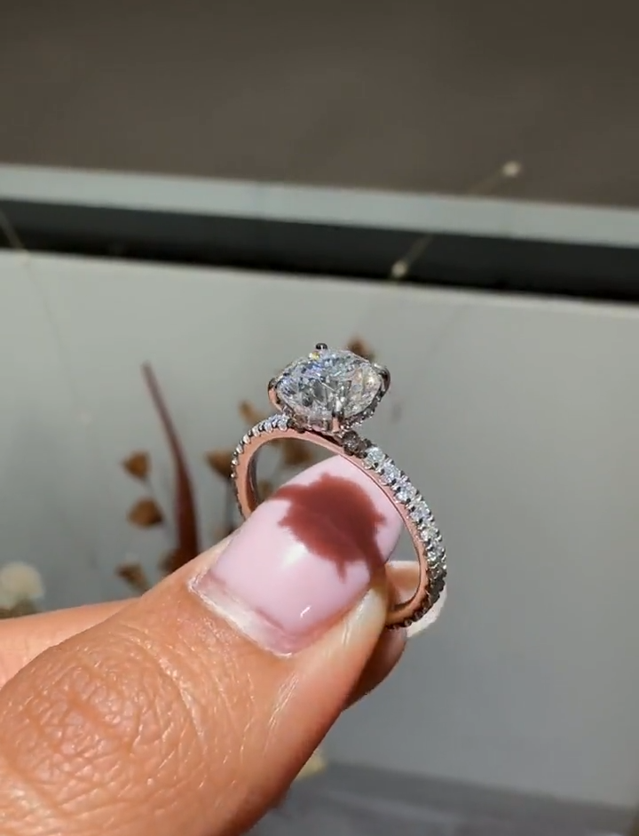 round cut diamond engagement ring with pave band and hidden halo