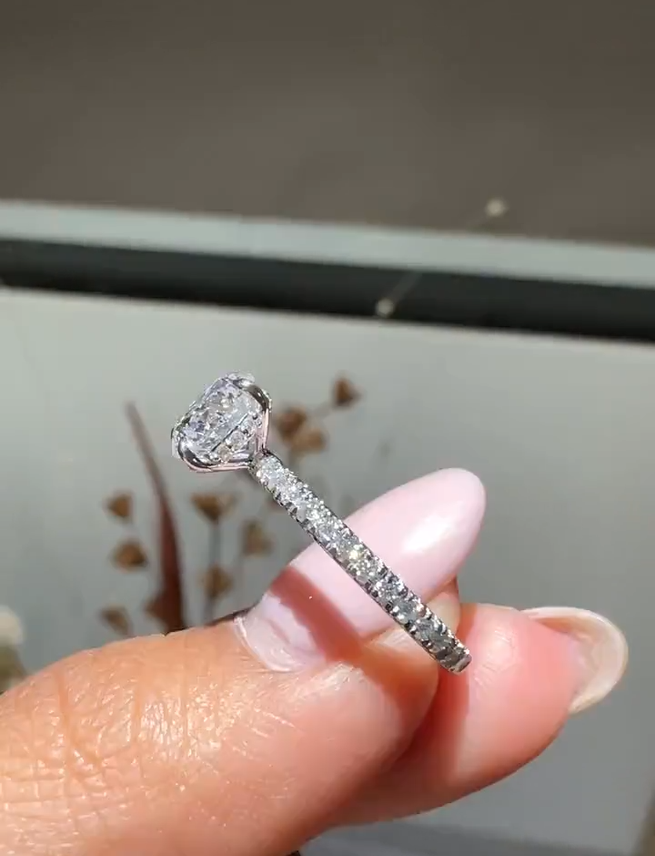 round cut diamond engagement ring with pave band and hidden halo