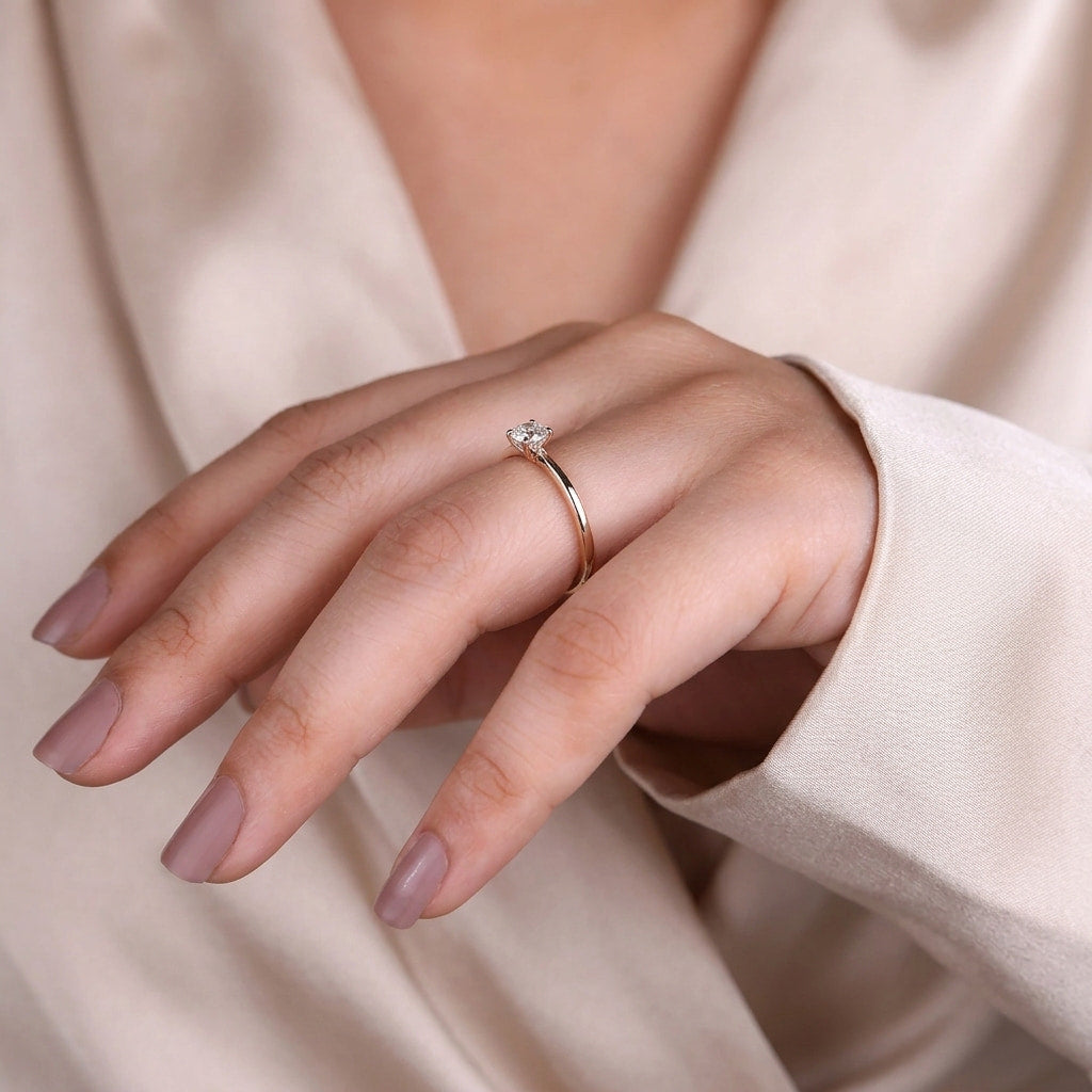 round cut diamond solitaire engagement ring with dainty plain band