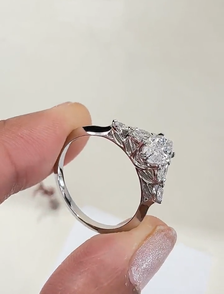 marquise cut diamond engagement ring with leaf cluster side stones