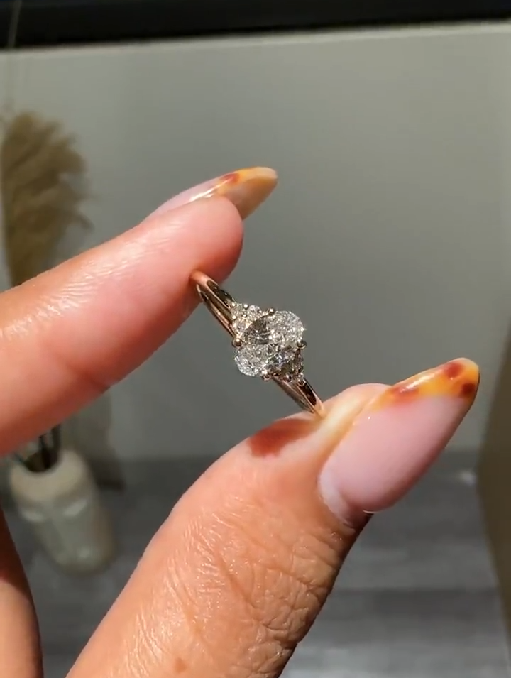 oval cut diamond engagement ring with cluster side accents