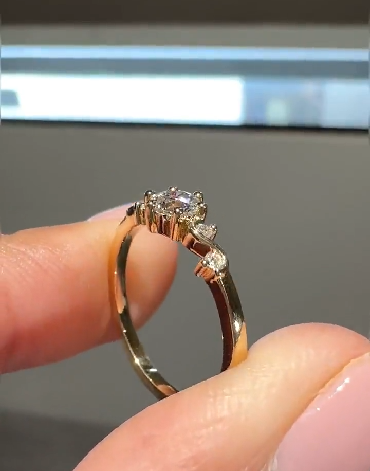 round cut diamond engagement ring with vine accent band