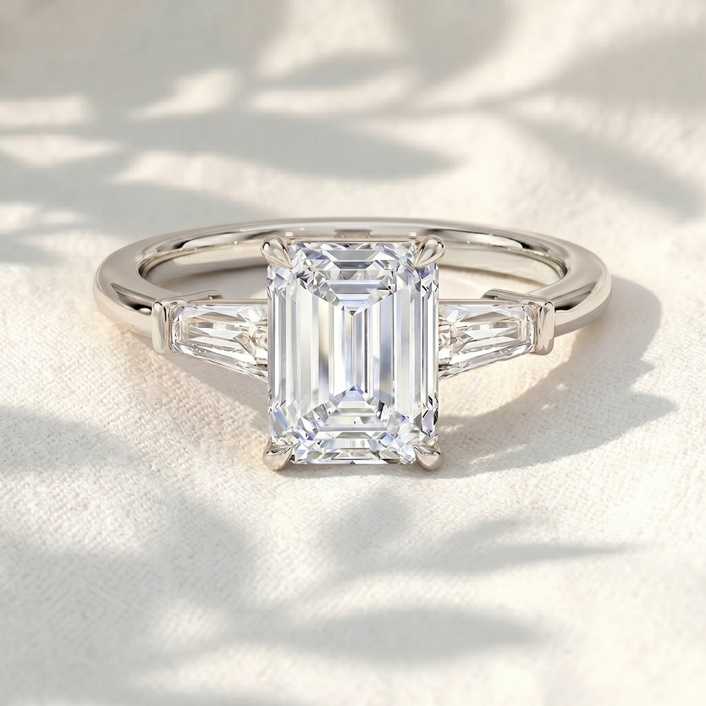 emerald cut lab grown diamond three stone engagement ring with tapered baguette side stones