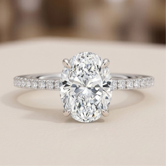 oval lab grown diamond pavé engagement ring in gold – four prong solitaire with hidden halo