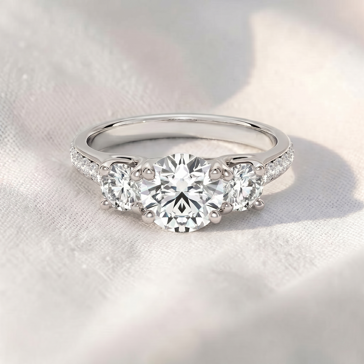 round lab grown diamond three stone engagement ring with pavé band